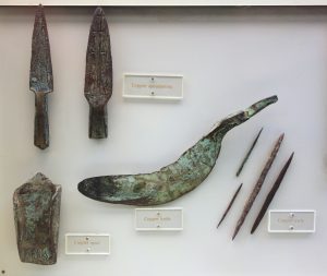 Several tools made from copper. There are two spearpoints, a knife, a spud and four awls.